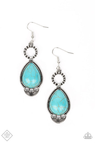 A silver ring decorated in a rustic dot motif anchors a turquoise stone teardrop, creating a swaying pendant. The stone is encased in a textured frame that features a flared bottom edge with airy scalloped cutouts. Earring attaches to a standard fishhook fitting. As the stone elements in this piece are natural, some color variation is normal.  Sold as one pair of earrings.