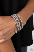 Load image into Gallery viewer, Row after row of gray suede cords layer around the wrist. Varying sizes of shiny silver studs coalesce across the cords in an out-of-this-world pattern for a starry statement. Features a magnetic closure.  Sold as one individual bracelet
