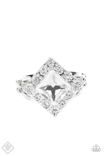 An oversized, square-cut, white rhinestone is tilted on a point and framed by tiny white gems. As it sits atop a pair of sleek silver bands, the faceted surface of the centerpiece catches and reflects the light of the accents that surround it, magnifying its impressive impact. Features a dainty stretchy band for a flexible fit.  Sold as one individual ring.