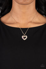 Load image into Gallery viewer, A luxurious airy gold heart lush with glassy white rhinestones swings from a classic gold chain. A faceted heart gem brushed in an iridescent shimmer graces one side of the larger bedazzled heart for a romantic finish. Features an adjustable clasp closure. Due to its prismatic palette, color may vary. 
