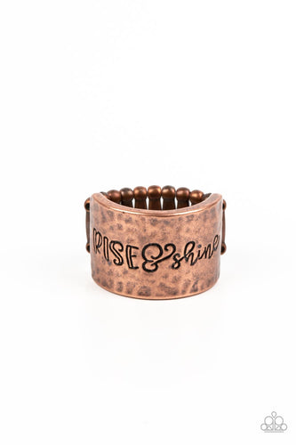 Across a wide copper band with a hammered sheen, the phrase 