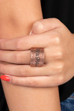 Load image into Gallery viewer, Across a wide copper band with a hammered sheen, the phrase &quot;Rise &amp; Shine&quot; is stamped in varying fonts for a merry message. Features a stretchy band for a flexible fit.
