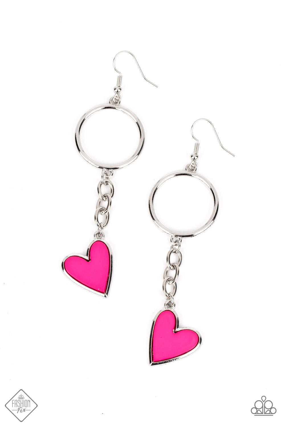 A vibrant pink heart, set atop a silver backing, swings from a strand of silver chain in a carefree cascade. A thick silver hoop anchors the pendant, adding a handcrafted touch to the design. Earring attaches to a standard fishhook fitting.  Sold as one pair of earrings.