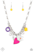 Load image into Gallery viewer, Elongated silver chain links, separated by tiny silver beads, lead down the neckline to a section of thick, flat, silver curb chain. A collection of whimsical charms gather along the thicker chain, including a lightning bolt, a star, a purple ring, a silhouette of a flower, a vibrant yellow bead, a pink heart, and a polished white baroque pearl. Features an adjustable clasp closure.  Sold as one individual necklace. Includes one pair of matching earrings.
