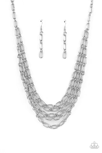 A strand of textured silver links gives way to layers of identical chains that drape across the chest in a stunning industrial display. The textured links catch and reflect the light at every angle, adding breathtaking shimmer to the monochromatic design. Features an adjustable clasp closure.