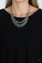 Load image into Gallery viewer, A strand of textured silver links gives way to layers of identical chains that drape across the chest in a stunning industrial display. The textured links catch and reflect the light at every angle, adding breathtaking shimmer to the monochromatic design. Features an adjustable clasp closure.

