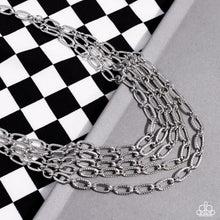 Load image into Gallery viewer, A strand of textured silver links gives way to layers of identical chains that drape across the chest in a stunning industrial display. The textured links catch and reflect the light at every angle, adding breathtaking shimmer to the monochromatic design. Features an adjustable clasp closure.
