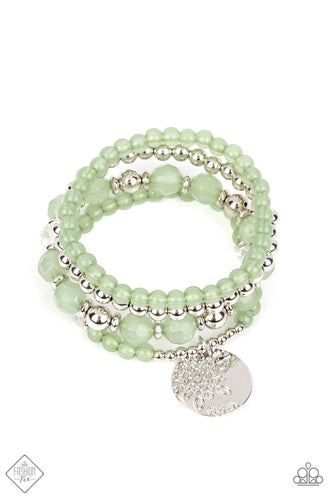 Opaque beads in the refreshing hue of Loden Frost combine with classic silver beads and clear beads brushed in a subtle reflective finish to create a stack of stretchy bracelets. Both sides of a silver disc are stamped with an abstract floral design and the word, 