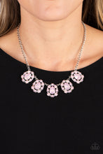 Load image into Gallery viewer, Encased in shimmery silver frames, a collection of pink, opalescent, teardrop gems twinkles above the collar. Dainty pink pearls, pink crystal-like gems, and rhinestones in an iridescent finish surround each teardrop, amplifying their dreamy disposition as the clusters connect to a classic silver chain. Features an adjustable clasp closure. Due to its prismatic palette, color may vary.  Sold as one individual necklace. Includes one pair of matching earrings.
