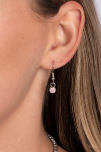 Encased in shimmery silver frames, a collection of pink, opalescent, teardrop gems twinkles above the collar. Dainty pink pearls, pink crystal-like gems, and rhinestones in an iridescent finish surround each teardrop, amplifying their dreamy disposition as the clusters connect to a classic silver chain. Features an adjustable clasp closure. Due to its prismatic palette, color may vary.  Sold as one individual necklace. Includes one pair of matching earrings.