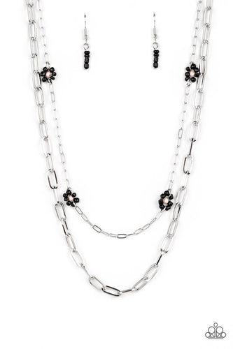 Elongated silver ovals link together to create an industrially edgy sheen below the collar. A slightly daintier version of the same style of chain layers above, dotted with black seed bead flowers with pink centers that add playful pops of color along the way. Features an adjustable clasp closure. 