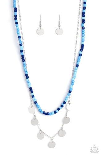Varying shades of blue seed beads are threaded along a wire, falling along the collar in a capricious pattern. A delicate silver chain, infused with twinkling silver discs, layers together with the colorful beads for a sassy, yet sweet, combo. Features an adjustable clasp closure. 