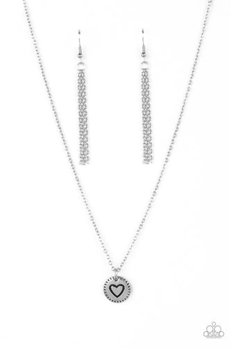Stamped in a heart burst pattern, a round silver pendant is suspended from a dainty silver chain for a sentimentally sleek design. Features an adjustable clasp closure.