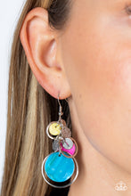 Load image into Gallery viewer, A colorful collection of yellow, hot pink, and turquoise shell-like discs and dainty silver rings dances from the top of a fishhook setting, gradually increasing in size as they fall further down the ear. Connected to the top-most hoop, silver-dotted leaf charms swing for additional eye-catching movement, resulting in a beach inspired lure. Earring attaches to a standard fishhook fitting.  Sold as one pair of earrings.
