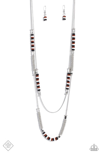 Featuring a layered display, two elongated silver snake chains dance down the neckline. Sections of shiny silver flower beads, capped by high sheen silver accents, are interspersed with stacks of white, Caramel Café, black, and silver studded beads, creating a bubbly, fanciful finish in rich neutral shades. Features an adjustable clasp closure.  Sold as one individual necklace. Includes one pair of matching earrings.