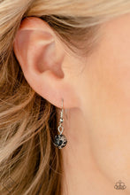 Load image into Gallery viewer, Marbled black stones are encased in classic silver frames and attached to the inside edges of warped silver hoops. The haphazard placement of the stones and the irregular shape of the silver rings add a handcrafted touch to the design, as the asymmetrical frames fall along the collar at the end of a thick silver chain. Features an adjustable clasp closure. As the stone elements in this piece are natural, some color variation is normal.
