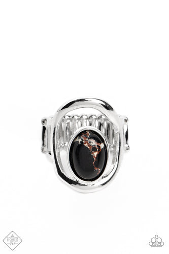 A marbled black stone is wrapped in a thin border of silver and attached to the inside edge of a warped oval frame. The open frame allows the skin to peek through, creating a unique statement piece atop the finger. Features a stretchy band for a flexible fit. As the stone elements in this piece are natural, some color variation is normal.  Sold as one individual ring.