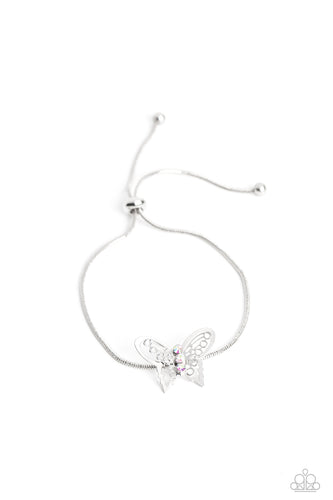A deceptively simple silver butterfly charm glides along a silver snake chain for a whimsical flair along the wrist. Dainty, iridescent rhinestones encrust along the butterfly's body, creating an understated shimmer, while intricate, airy wings fold out from the sparkle, adding a 3D effect to the design. Features an adjustable sliding knot closure. Due to its prismatic palette, color may vary.