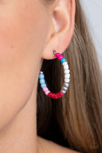 Load image into Gallery viewer, A colorful strand of hot pink, blue, white, silver, red, light pink, and baby blue seed beads follow the curve of a silver hoop, creating a colorfully charismatic look. Earring attaches to a standard post fitting. Hoop measures approximately 1 1/4&quot; in diameter.
