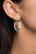 Load image into Gallery viewer, A colorful strand of green, royal blue, white, reflective yellow, gold, blue, orange, and pink seed beads follow the curve of a silver hoop, creating a colorfully charismatic look. Earring attaches to a standard post fitting. Hoop measures approximately 1 1/4&quot; in diameter. 
