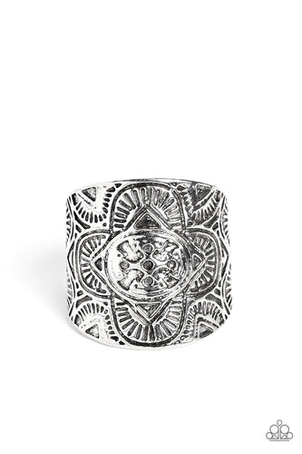 Engraved geometric shapes, lines, and patterns fill a silver plate that curves around the finger, creating a trendy centerpiece. Features a stretchy band for a flexible fit.