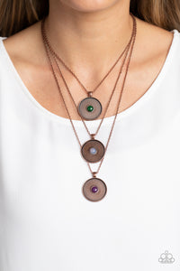 Stamped with a floral motif, oversized copper pendants trickle from three layered chains below the neckline for a casual style. Featured in the center of each disc, a jade, opal white, and amethyst stone create a pop of color against the textured backdrop. Features an adjustable clasp closure. As the stone elements in this piece are natural, some color variation is normal.