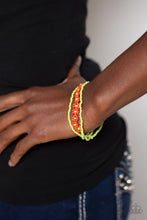 Load image into Gallery viewer, Strung along the entirety of three elastic stretchy bands, apple green seed beads coalesce around the wrist. Featured on one of the bands of green seed beads, blooming red seed bead flowers, with yellow seed bead centers haphazardly interrupt the refreshing collection for a carefree, charismatic finish. 
