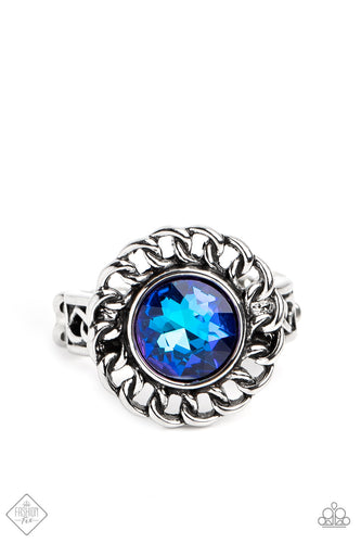 High-sheen silver chain links encircle a vibrant, faceted blue gem center, creating a gorgeous contrast of grit and glam. A band of silver chain link arcs across the finger underneath the colorful centerpiece, resulting in an edgy centerpiece that sits boldly atop the finger. Features a dainty stretchy band for a flexible fit.  Sold as one individual ring.  New Kit Fashion Fix