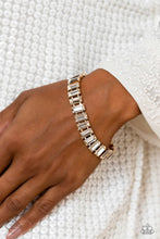 Load image into Gallery viewer, Set in prominent, pronged gold fittings, a glassy collection of emerald-cut, white gems fall in line around the wrist, creating a stunning, light-catching display. Features an adjustable clasp closure.  Sold as one individual bracelet.
