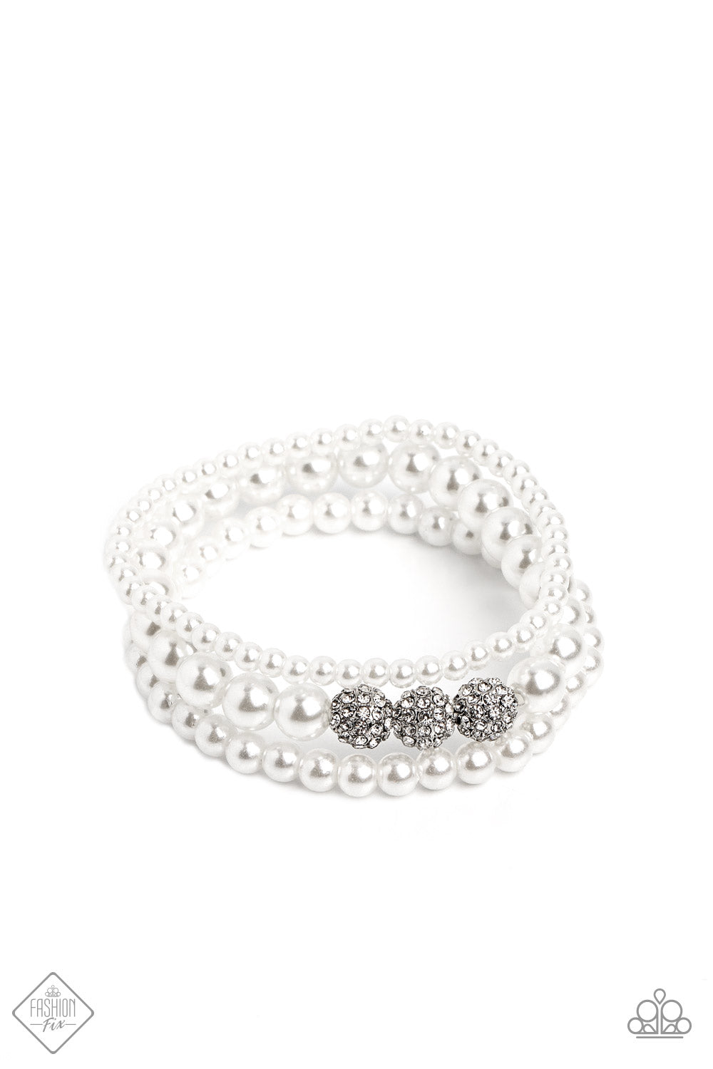 Three strands of classic white pearls, each in varying sizes, coalesce around the wrist on elastic stretchy bands into a feminine display. A trio of rhinestone-encrusted spheres dots the largest strand of pearls, infusing the design with capricious shimmer.  Sold as one set of three bracelets.  New Kit Fashion Fix