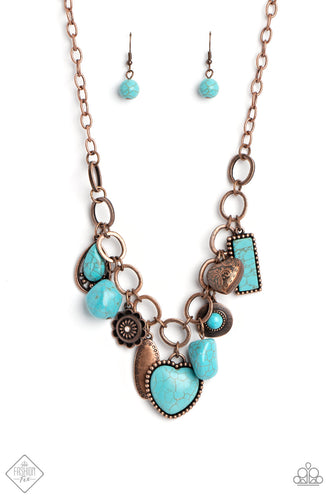 A hodgepodge of charms and unfinished turquoise stones dance whimsically along the neckline as they swing from a section of oversized copper links. Vintage filigree and polished copper studs add detail and texture to each element, resulting in a handcrafted statement piece rich in character. Features an adjustable clasp closure.     Sold as one individual necklace. Includes one pair of matching earrings.