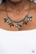Load image into Gallery viewer, Featuring smoldering marquise style cuts, oversized smoky gems fan out from an interconnected, circular smoky rhinestone display. Separating the dauntless florals, airy brass ovals, stamped with a dot motif, create additional eye-catching sheen. Features an adjustable clasp closure.
