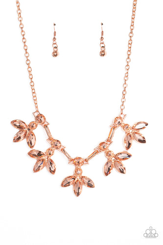 Featuring warm marquise style cuts, oversized peachy gems fan out from an interconnected, circular peachy rhinestone display. Separating the warm florals, airy shiny copper ovals, stamped with a dot motif, create additional eye-catching sheen. Features an adjustable clasp closure. 