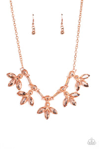 Featuring warm marquise style cuts, oversized peachy gems fan out from an interconnected, circular peachy rhinestone display. Separating the warm florals, airy shiny copper ovals, stamped with a dot motif, create additional eye-catching sheen. Features an adjustable clasp closure. 
