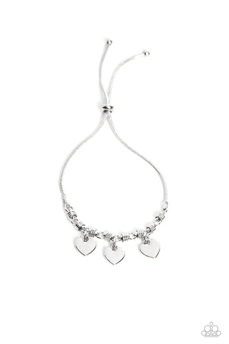 Dangling from a silver snake chain, a trio of silver hearts link across the wrist for a dash of swoon-worthy sheen. Infused along the heart chain, silver spiral-like accents add additional texture to the monochromatic design. Features an adjustable sliding knot closure.