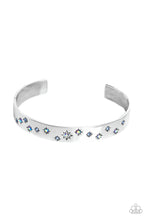 Load image into Gallery viewer, Tinted in subtle, stellar shades of blue and iridescence, dainty rhinestones are pressed into the centers of stamped stars in varying sizes. Embossed in tactile textures, the starry collection wraps around the wrist against a backdrop of a high-sheen silver cuff, emitting further glow to the design. Due to its prismatic palette, color may vary.
