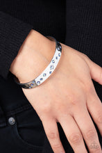 Load image into Gallery viewer, Tinted in subtle, stellar shades of blue and iridescence, dainty rhinestones are pressed into the centers of stamped stars in varying sizes. Embossed in tactile textures, the starry collection wraps around the wrist against a backdrop of a high-sheen silver cuff, emitting further glow to the design. Due to its prismatic palette, color may vary.
