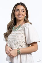 Load image into Gallery viewer, Shiny silver cubed accents, cloudy, milky, green oval beads and milky peach beads coalesce down the neckline on invisible wires, creating a trio of colorful layers. Features an adjustable clasp closure.
