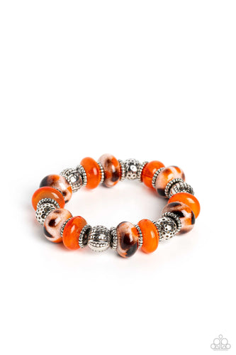 An earthy collection of dotted silver beads, rounded milky orange beads, studded silver rings, orange-spotted ceramic-like beads and textured silver beads are threaded along an elastic stretchy band around the wrist for an authentic artisan flair.