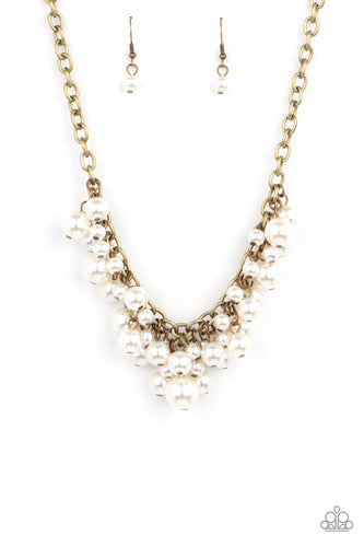 A bubbly collection of classic and oversized white pearls swing from the bottom of a rustic brass chain, creating a dramatic fringe below the collar. Features an adjustable clasp closure.  Sold as one individual necklace. Includes one pair of matching earrings.