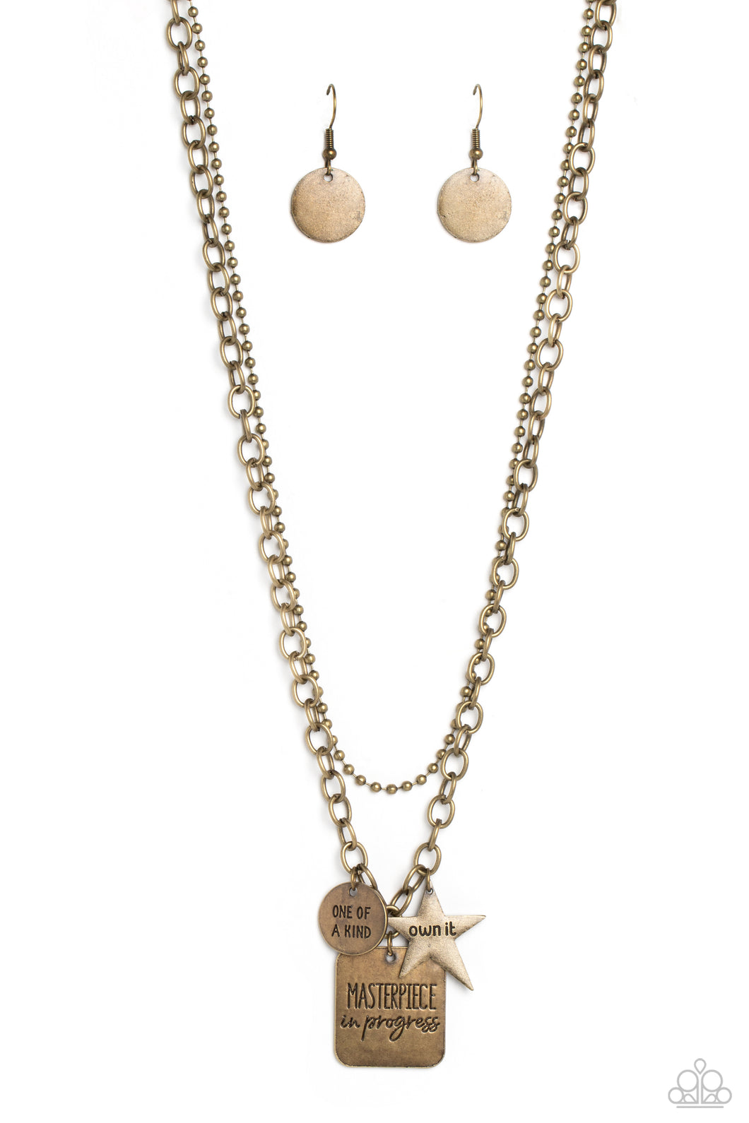 Featuring three inspirational pendants, a brass star, circle, and square fall along a brass chain. The star features the phrase 