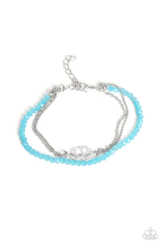 Faceted blue beads combine with a dainty silver chain, and a dainty silver ball chain for a colorful display around the wrist. Falling from the classic chain, an airy silver lotus blooms, adding a whimsical floral display to the design. Features an adjustable clasp closure.