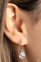 Load image into Gallery viewer, A small, skinny, shiny silver hoop curves around the ear in a timeless fashion. A shiny silver ball is affixed to the end of the hoop, reminiscent of a barbell fitting. A white, teardrop gem, encased in a shiny silver frame slides along the curvature of the hoop, adding a surprising hint of shimmery movement. Earring attaches to a standard post fitting. Hoop measures approximately 1/2&quot; in diameter. 
