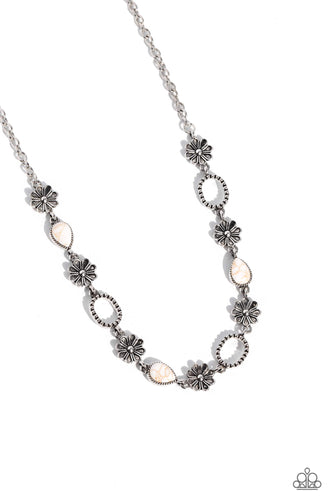 Pieces of amethyst stones shift back and forth inside a glassy frame encased in a silver compass-like fitting, resulting in a dramatically earthy pendant at the bottom of an extended silver chain. Features an adjustable clasp closure.