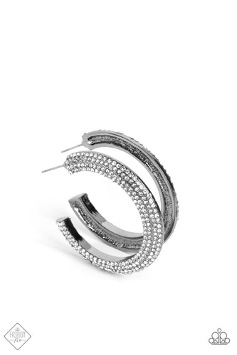Countless white rhinestones are encrusted along the outer surface of a thick gunmetal hoop, creating a stunning display of glitz against a polished background. Earring attaches to a standard post fitting. Hoop measures approximately 1 1/2