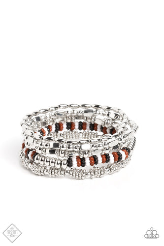 Silver oval beads, faceted silver beads, white, Caramel Café, black, and silver studded beads, and elongated cubed silver beads stack on top of one another along elastic stretchy bands to create a bubbly, fanciful stack.  Sold as one set of five bracelets.