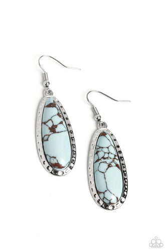 Elongating past the ear, a blue teardrop stone, marbled with natural accents is pressed into an antiqued-hammered silver frame, creating an earthy statement. Earring attaches to a standard fishhook fitting. As the stone elements in this piece are natural, some color variation is normal.  Sold as one pair of earrings.