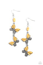 Load image into Gallery viewer, Two butterflies, with wings of silver filigree, and yellow stones, flutter below an oval yellow stone, creating a free-spirited lure. Each butterfly swings in whimsical asymmetry, creating the look of butterflies flying in alternating directions. Earring attaches to a standard fishhook fitting. As the stone elements in this piece are natural, some color variation is normal. 
