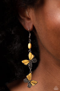 Two butterflies, with wings of silver filigree, and yellow stones, flutter below an oval yellow stone, creating a free-spirited lure. Each butterfly swings in whimsical asymmetry, creating the look of butterflies flying in alternating directions. Earring attaches to a standard fishhook fitting. As the stone elements in this piece are natural, some color variation is normal. 