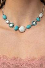 Load image into Gallery viewer, A collection of turquoise stones and white opalescent beads are featured in a range of pronged silver fittings and floral patterns, falling along the neckline in an artisanal display. The haphazard placement of each element further emphasizes their handcrafted charm, as the opalescent beads bring a hint of shimmer to the design. Features an adjustable clasp closure. As the stone elements in this piece are natural, some color variation is normal.
